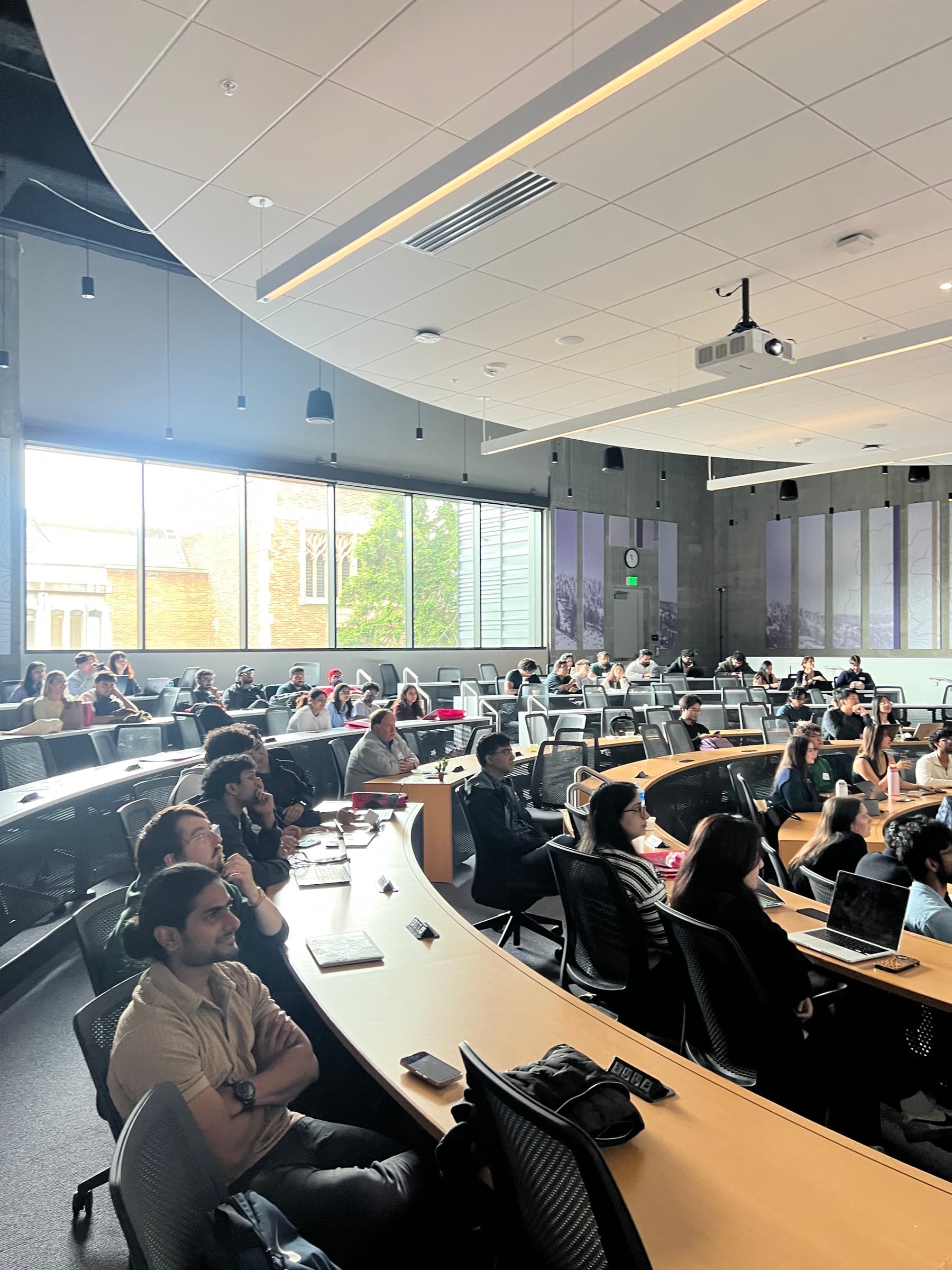 Rows of participants watching the front of the hackathon room.