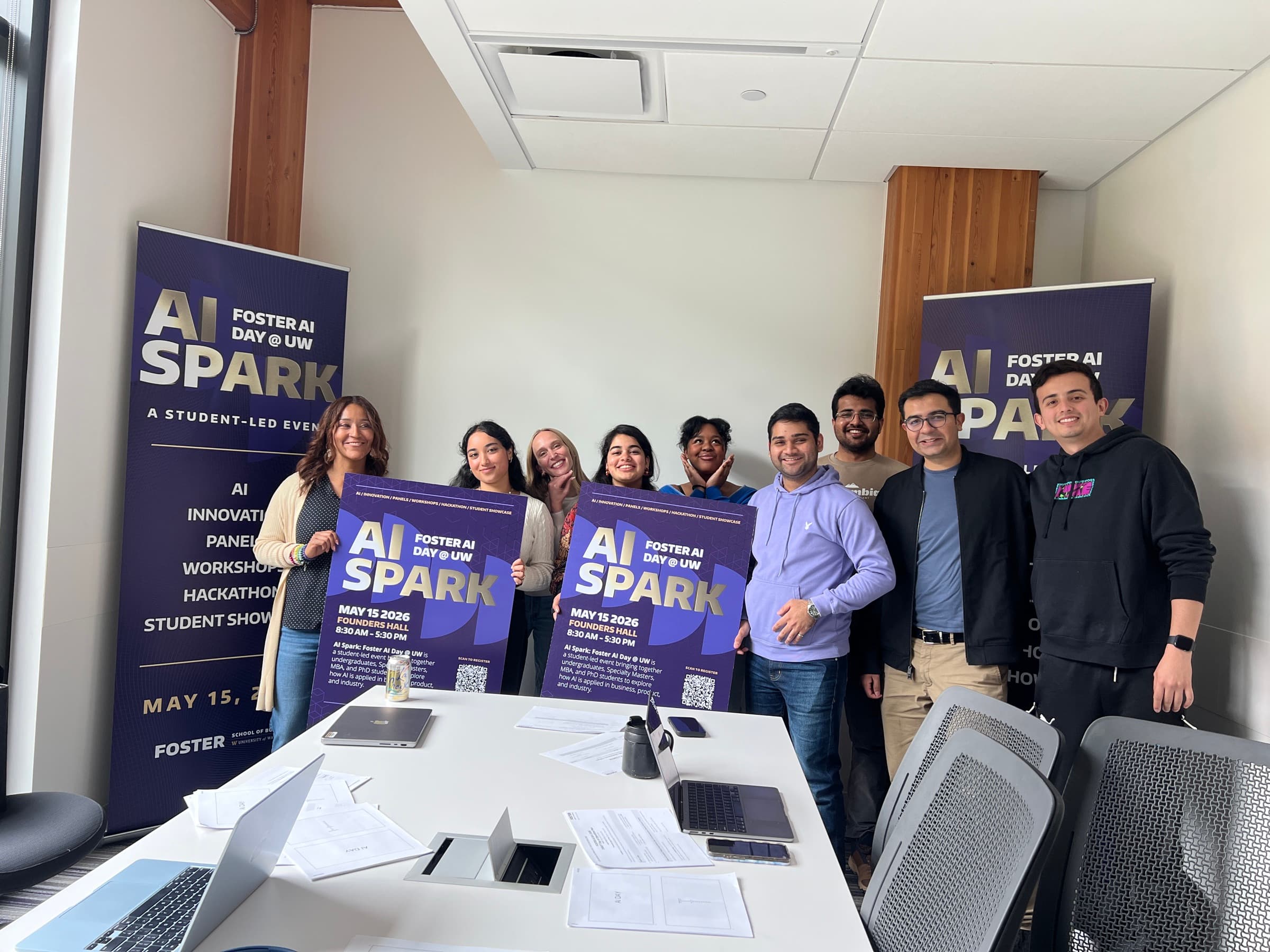 The Foster AI Day organizing team gathered with AI Spark banners and posters.