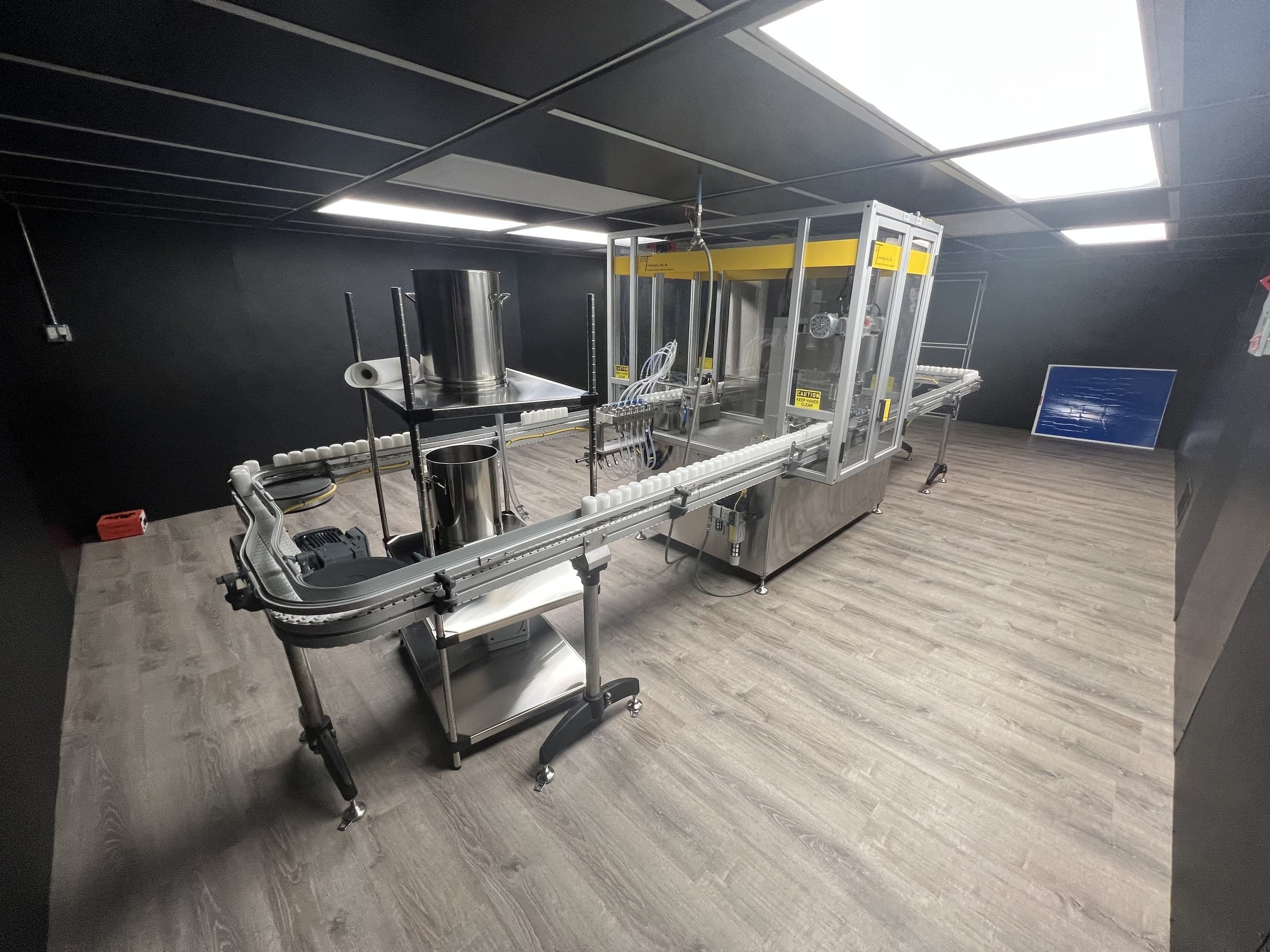 Conveyor and enclosed production equipment in a room at Empire.