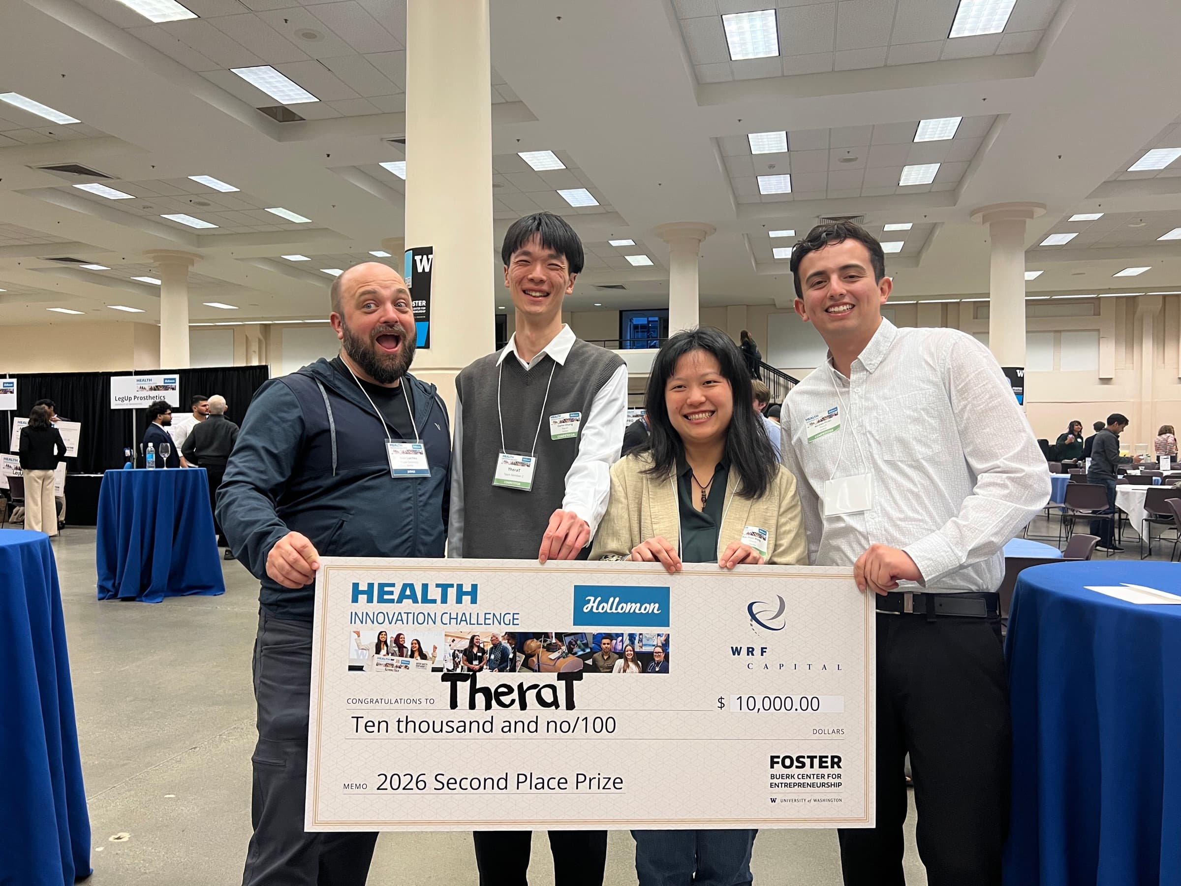 Nicolas, TheraT team members, and mentor Ivan Liachko celebrating with the second-place prize check.