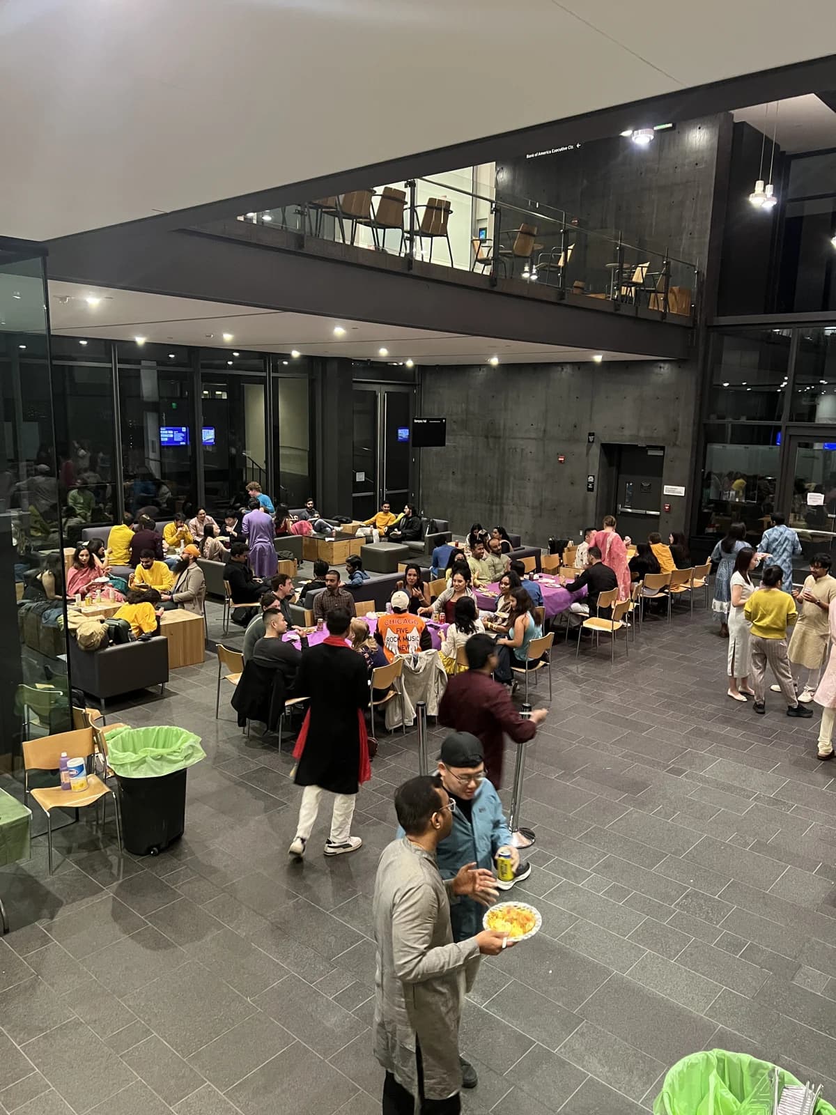 Guests gathered around tables in the Foster atrium during Diwali.