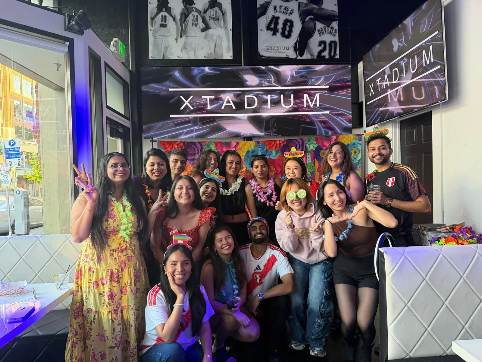 Guests posing with colorful photo props at Latin Carnival.