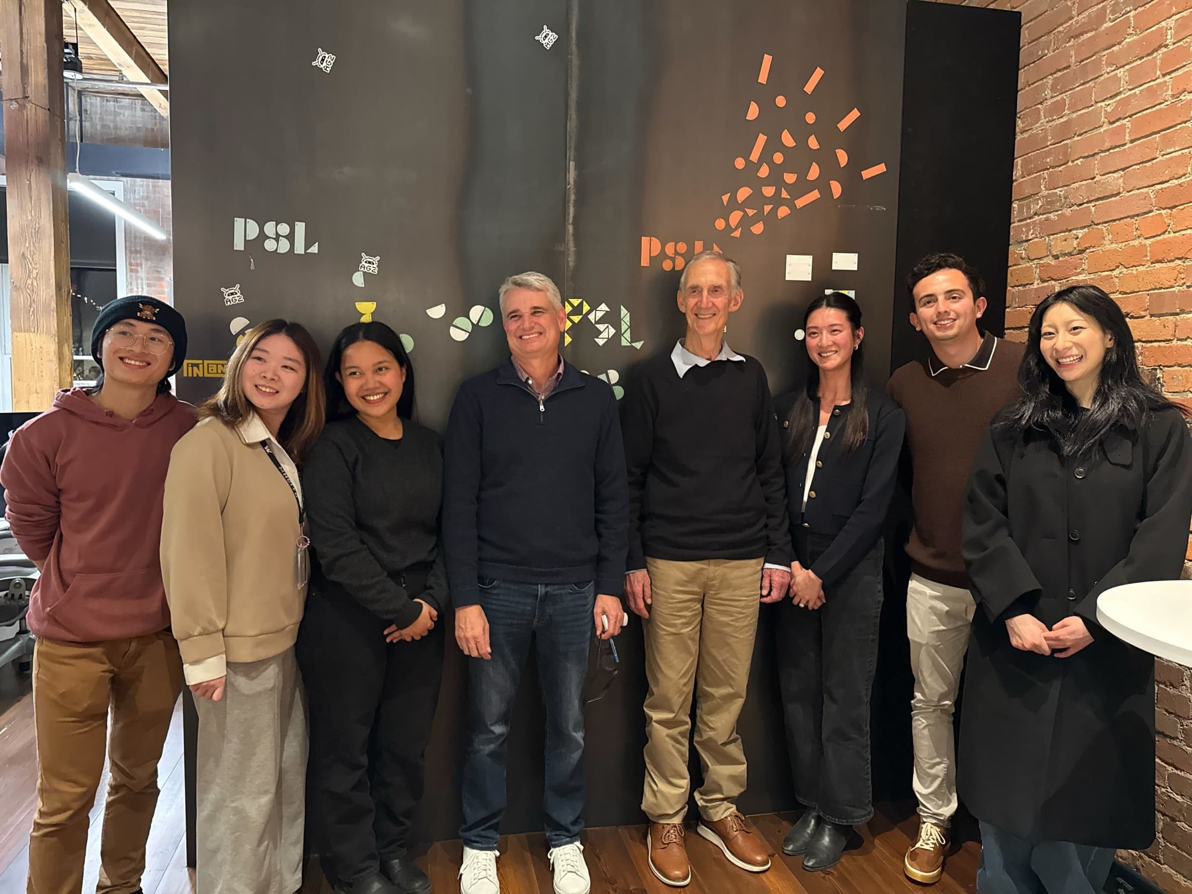 HeyLily team members with instructors Greg Gottesman and Ed Lazowska in front of a Pioneer Square Labs backdrop.